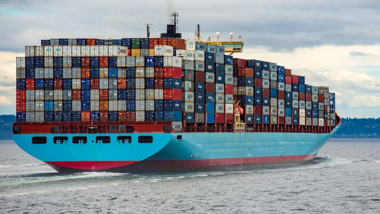 Container ship carrying sea freight near a commercial port